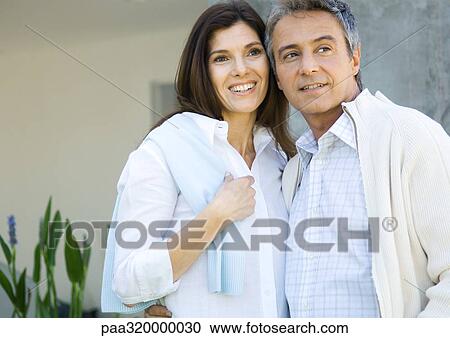 Mature couple standing together, smiling View Large Photo Image Stock Image - Mature couple standing together, smiling. Fotosearch