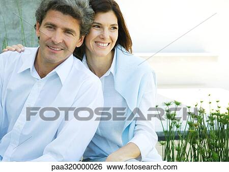 Stock Photograph - Mid-adult couple smiling. Fotosearch