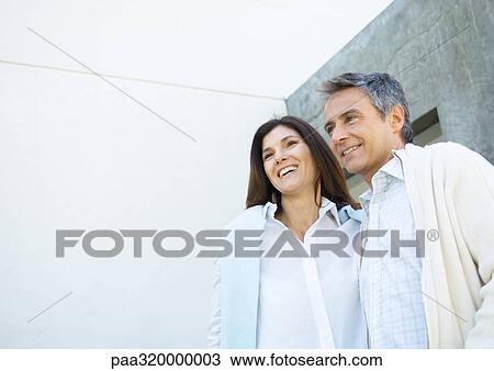 Stock Image - Mid-adult couple wearing button down shirts. Fotosearch