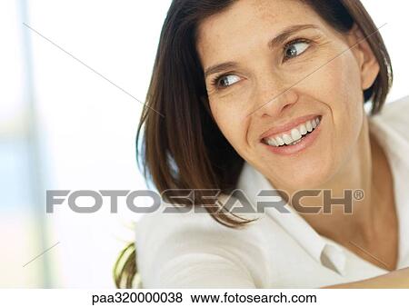 Mid-adult woman smiling, portrait View Large Photo Image Stock Photo - Mid-adult woman smiling, portrait. Fotosearch