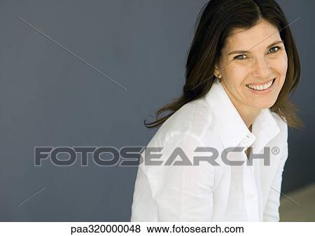 Mid-adult woman smiling, portrait View Large Photo Image Stock Photo - Mid-adult woman smiling, portrait. Fotosearch