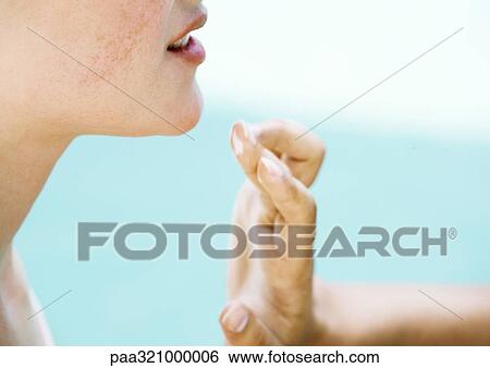 Stock Photograph - Woman applying moisturizer to face. Fotosearch