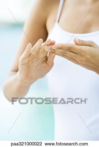 Woman applying moisturizer to hands View Large Photo Image Stock Image - Woman applying moisturizer to hands. Fotosearch