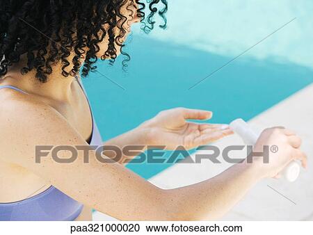 Woman applying sunscreen View Large Photo Image Stock Image - Woman applying sunscreen. Fotosearch