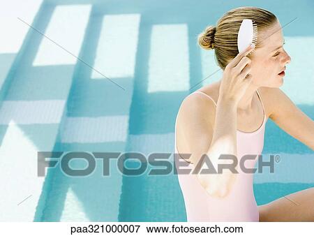 Woman brushing hair by side of pool View Large Photo Image Stock Photo - Woman brushing hair by side of pool. Fotosearch