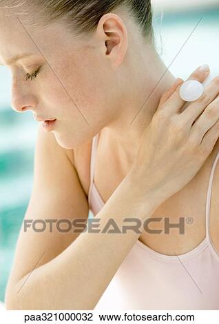 Stock Image - Woman massaging neck. Fotosearch