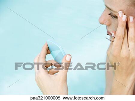 Stock Photography - Woman tweezing brows. Fotosearch
