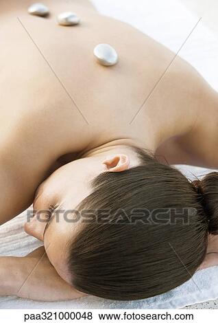 Woman with hot stones on back View Large Photo Image Stock Photo - Woman with hot stones on back. Fotosearch