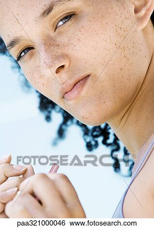 Stock Photograph - Young woman filing nails. Fotosearch