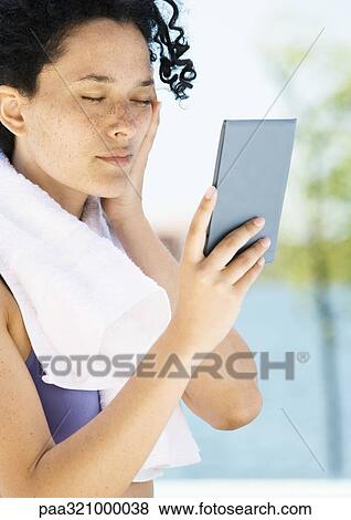 Young woman holding up hand mirror, eyes closed View Large Photo Image Stock Photo - Young woman holding up hand mirror, eyes closed. Fotosearch