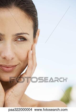 Woman holding face in hands, portrait View Large Photo Image Picture - Woman holding face in hands, portrait. Fotosearch