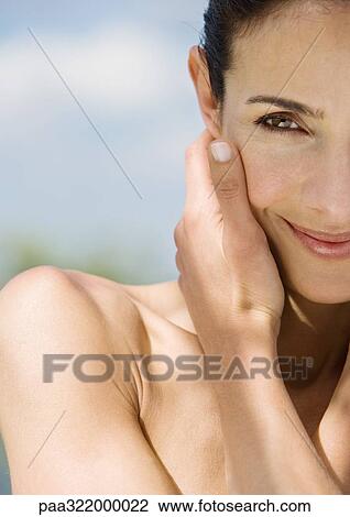 Woman touching face and smiling View Large Photo Image Stock Image - Woman touching face and smiling. Fotosearch