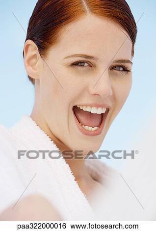 Woman wearing bathrobe, making excited face View Large Photo Image Stock Photograph - Woman wearing bathrobe, making excited face. Fotosearch