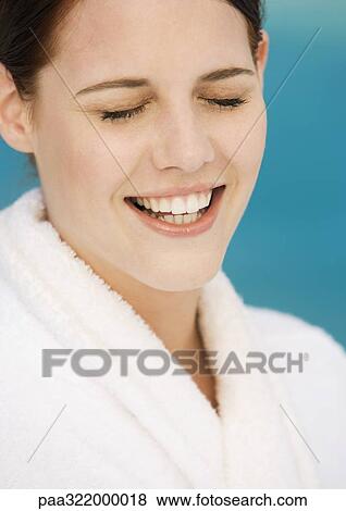 Woman wearing bathrobe, smiling with eyes closed View Large Photo Image Stock Photo - Woman wearing bathrobe, smiling with eyes closed. Fotosearch