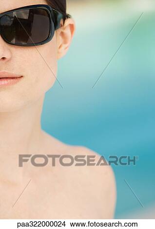 Woman wearing sunglasses View Large Photo Image Picture - Woman wearing sunglasses. Fotosearch
