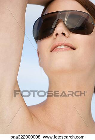 Stock Photo - Woman wearing sunglasses. Fotosearch