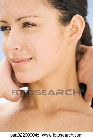 Woman with hands behind neck, close-up View Large Photo Image Stock Photography - Woman with hands behind neck, close-up. Fotosearch