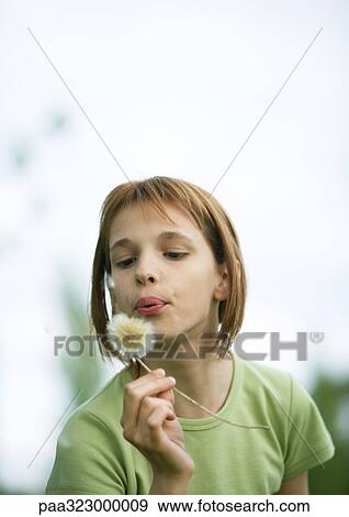 Girl blowing dandelion View Large Photo Image Stock Photo - Girl blowing dandelion. Fotosearch