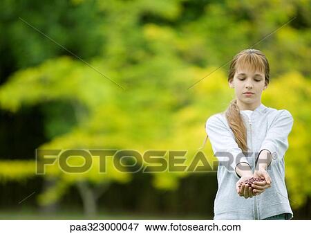 Girl holding out cupped hands View Large Photo Image Stock Photo - Girl holding out cupped hands. Fotosearch