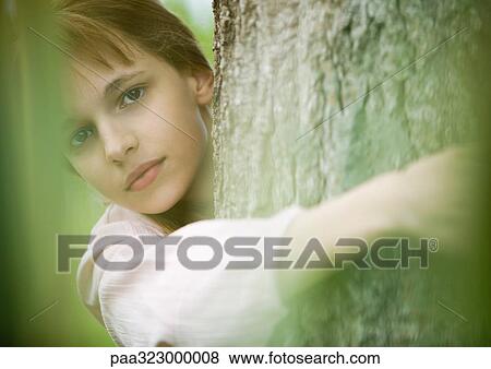 Stock Photo - Girl hugging tree. Fotosearch