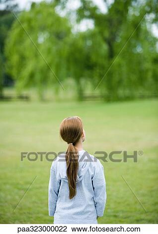 Girl looking out over field, rear view View Large Photo Image Stock Image - Girl looking out over field, rear view. Fotosearch