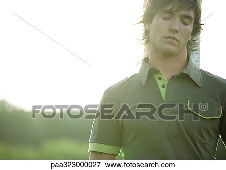 Man leaning against tree trunk with eyes closed View Large Photo Image Stock Photo - Man leaning against tree trunk with eyes closed. Fotosearch