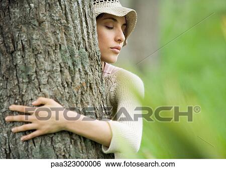 Woman hugging tree View Large Photo Image Stock Photograph - Woman hugging tree. Fotosearch