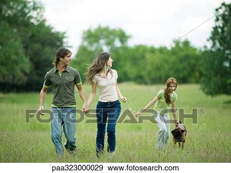 Young adult couple walking with girl and dog View Large Photo Image Stock Photo - Young adult couple walking with girl and dog. Fotosearch