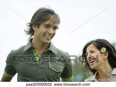 Young couple, woman wearing flower behind ear View Large Photo Image Stock Image - Young couple, woman wearing flower behind ear. Fotosearch