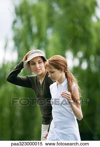 Young woman and girl walking together View Large Photo Image Stock Photography - Young woman and girl walking together. Fotosearch
