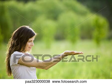 Young woman holding palms up View Large Photo Image Stock Photo - Young woman holding palms up. Fotosearch