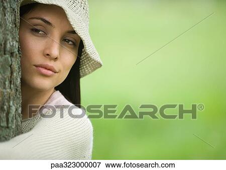 Young woman hugging tree, close-up of head and shoulders View Large Photo Image Stock Photo - Young woman hugging tree, close-up of head and shoulders. Fotosearch