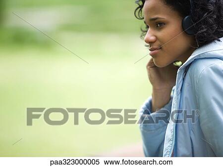 Young woman wearing headphones View Large Photo Image Stock Photography - Young woman wearing headphones. Fotosearch