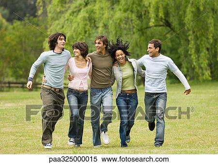 Group of young friends with arms around each other, skipping across field View Large Photo Image Stock Photography - Group of young friends with arms around each other, skipping across field. Fotosearch