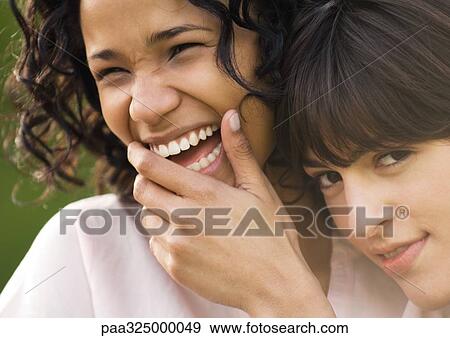 Two young female friends, one laughing View Large Photo Image Stock Photo - Two young female friends, one laughing. Fotosearch