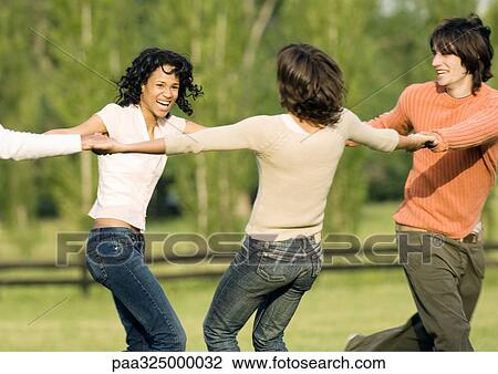 Young adult friends holding hands in circle View Large Photo Image Stock Image - Young adult friends holding hands in circle. Fotosearch