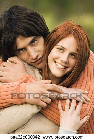 Young couple embracing, portrait View Large Photo Image Stock Image - Young couple embracing, portrait. Fotosearch