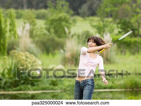Young woman swinging badminton racket View Large Photo Image Picture - Young woman swinging badminton racket. Fotosearch