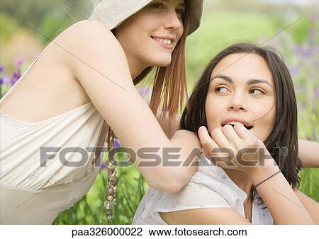 Two young female friends outdoors View Large Photo Image Stock Image - Two young female friends outdoors. Fotosearch