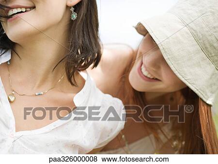 Stock Photo - Two young woman having fun, close-up. Fotosearch