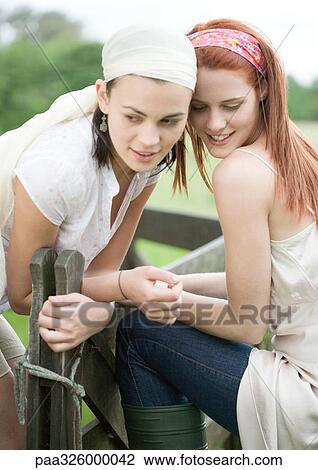 Two young women outdoors View Large Photo Image Stock Image - Two young women outdoors. Fotosearch