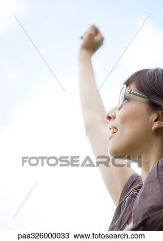 Woman wearing glasses, reaching arm upward View Large Photo Image Stock Image - Woman wearing glasses, reaching arm upward. Fotosearch
