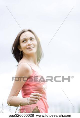 Young woman walking and looking back over shoulder, waist up View Large Photo Image Stock Photo - Young woman walking and looking back over shoulder, waist up. Fotosearch