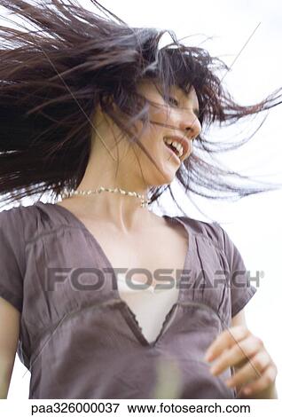 Young woman with hair flying View Large Photo Image Stock Photo - Young woman with hair flying. Fotosearch