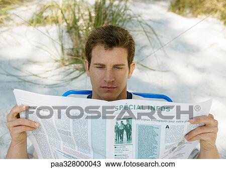 Man reading newspaper on beach View Large Photo Image Stock Image - Man reading newspaper on beach. Fotosearch