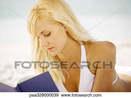 Woman reading book on beach View Large Photo Image Stock Photo - Woman reading book on beach. Fotosearch