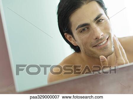 Man applying shaving cream in mirror View Large Photo Image Stock Photo - Man applying shaving cream in mirror. Fotosearch