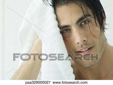 Stock Photo - Man drying hair with towel. Fotosearch