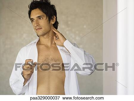 Man putting on fragrance View Large Photo Image Stock Photo - Man putting on fragrance. Fotosearch