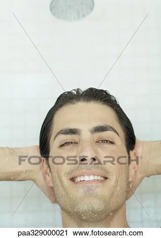 Man smiling with hands behind head in shower View Large Photo Image Stock Image - Man smiling with hands behind head in shower. Fotosearch